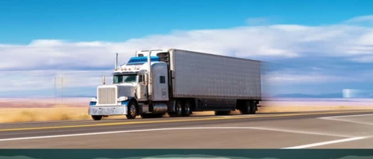American truck driving through flat desert